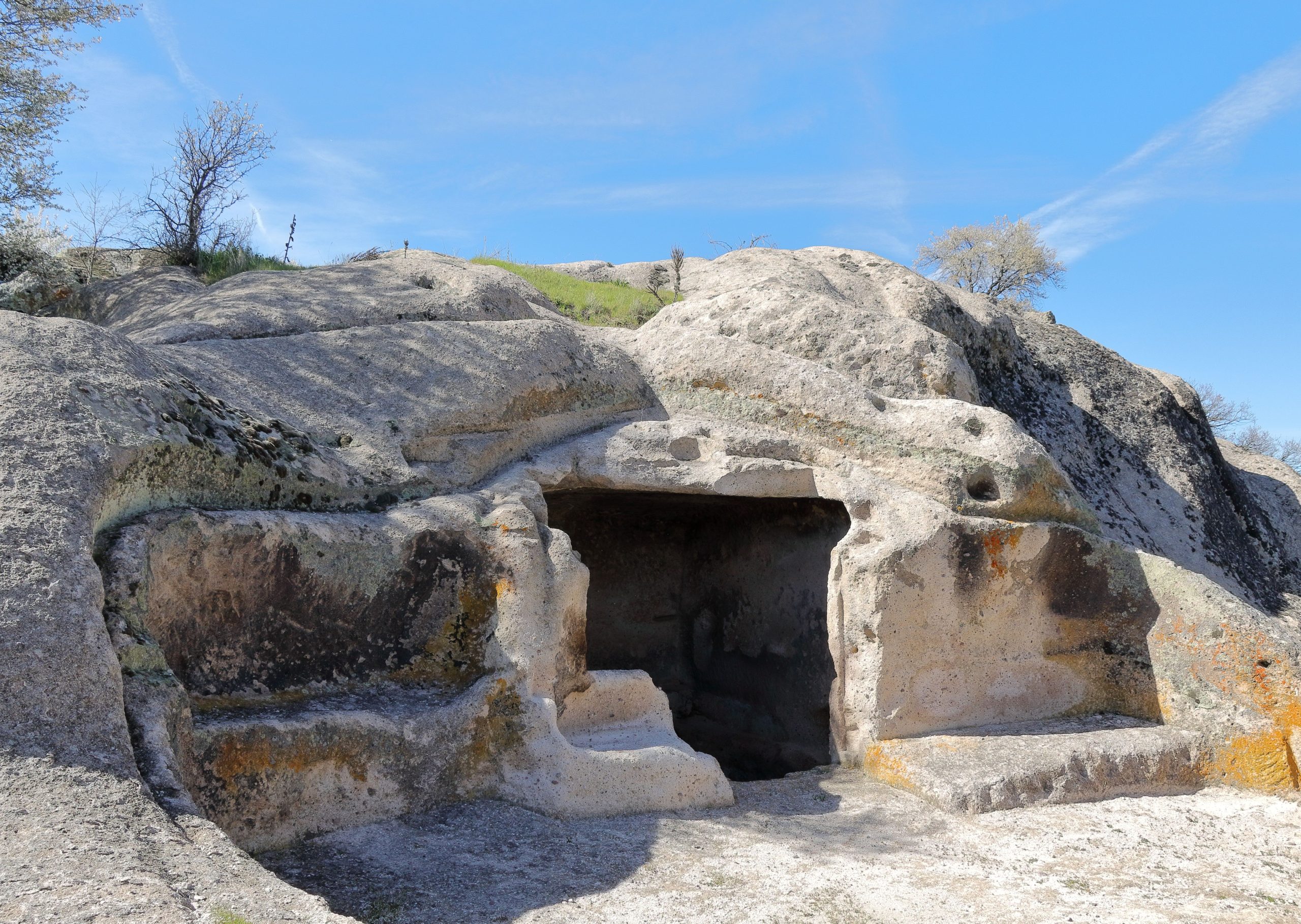 Grotte taillée dans la roche sous ciel bleu
