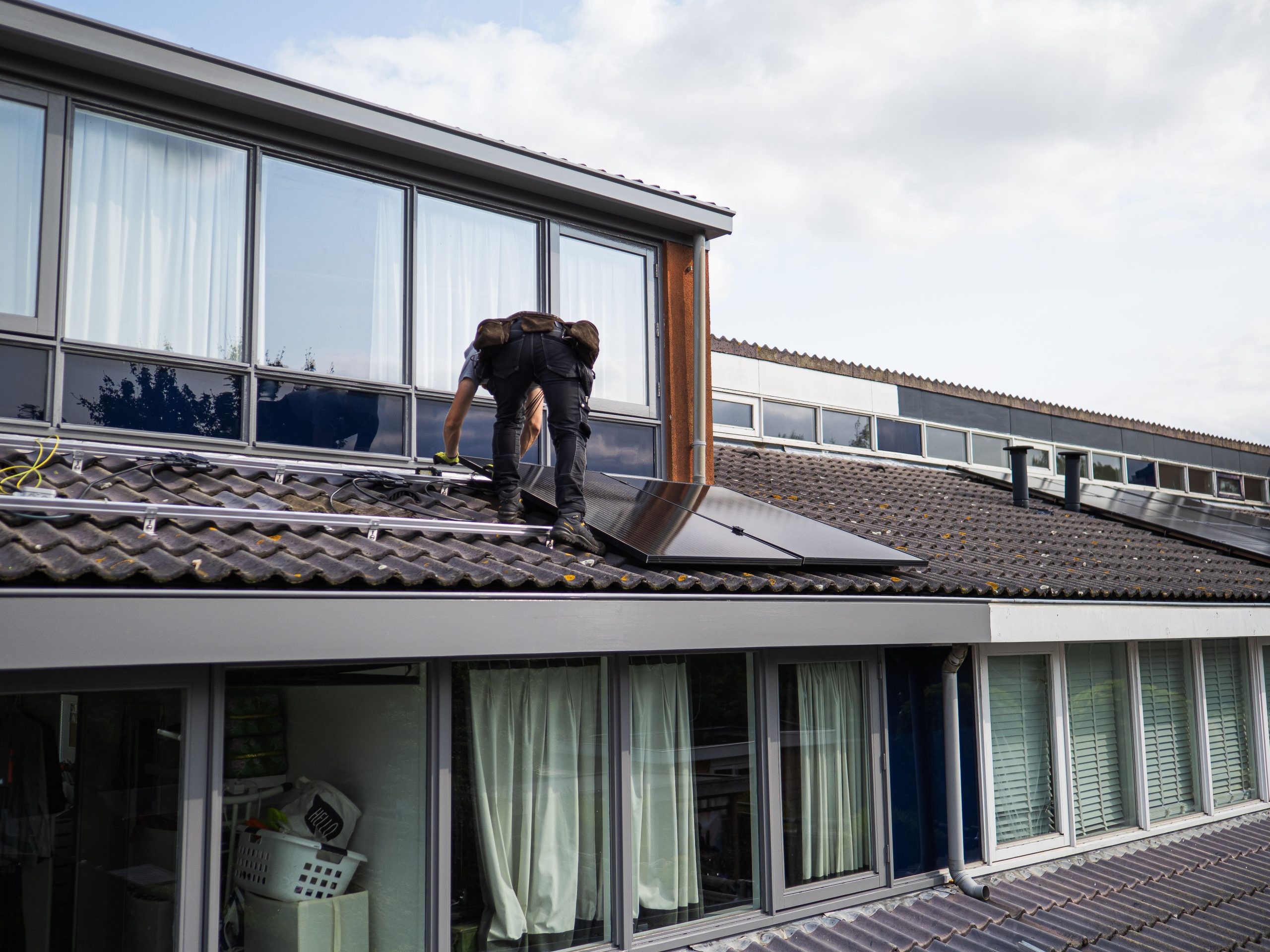 Technicien installant panneaux solaires toiture résidentielle