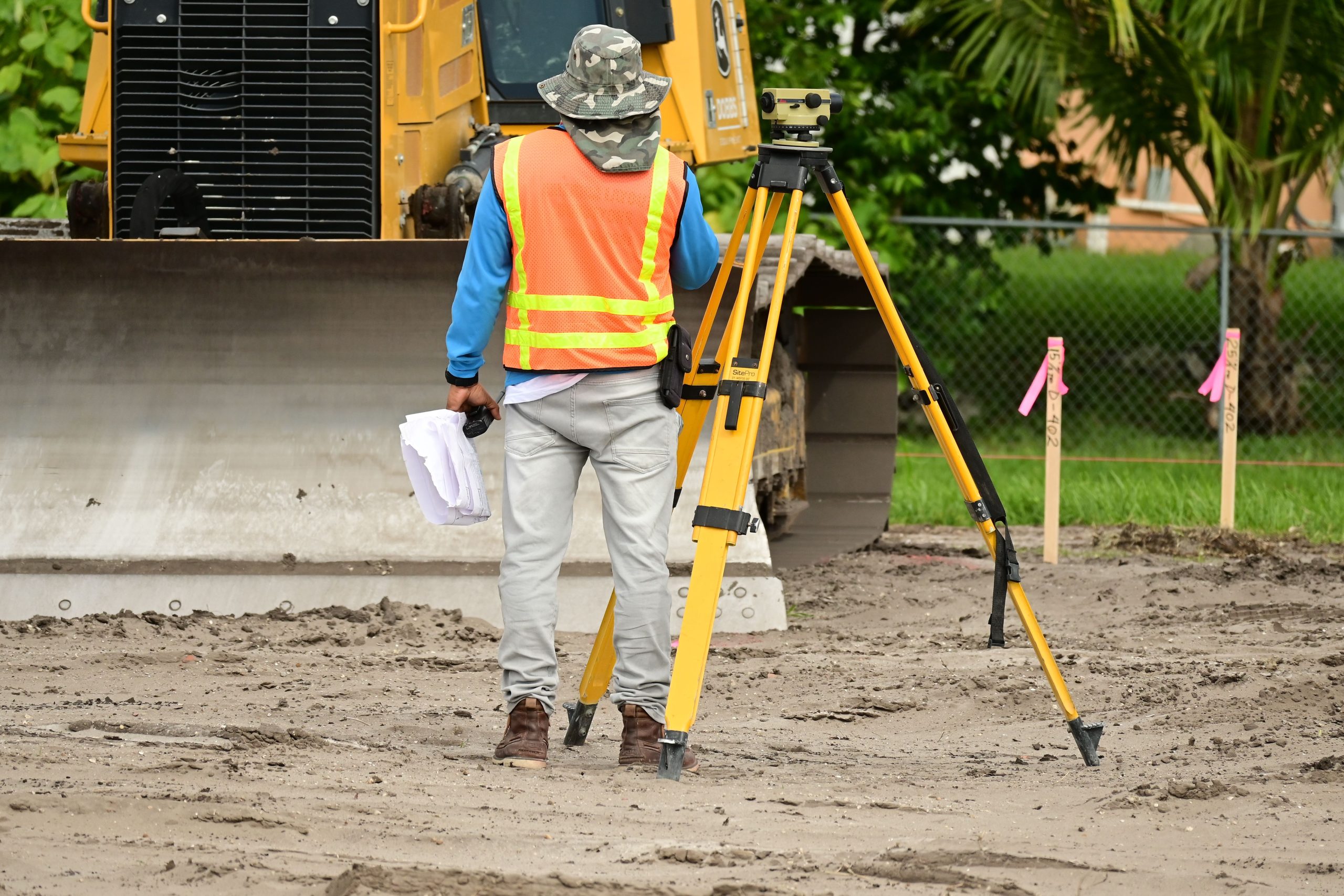 Géomètre mesurant un terrain de construction