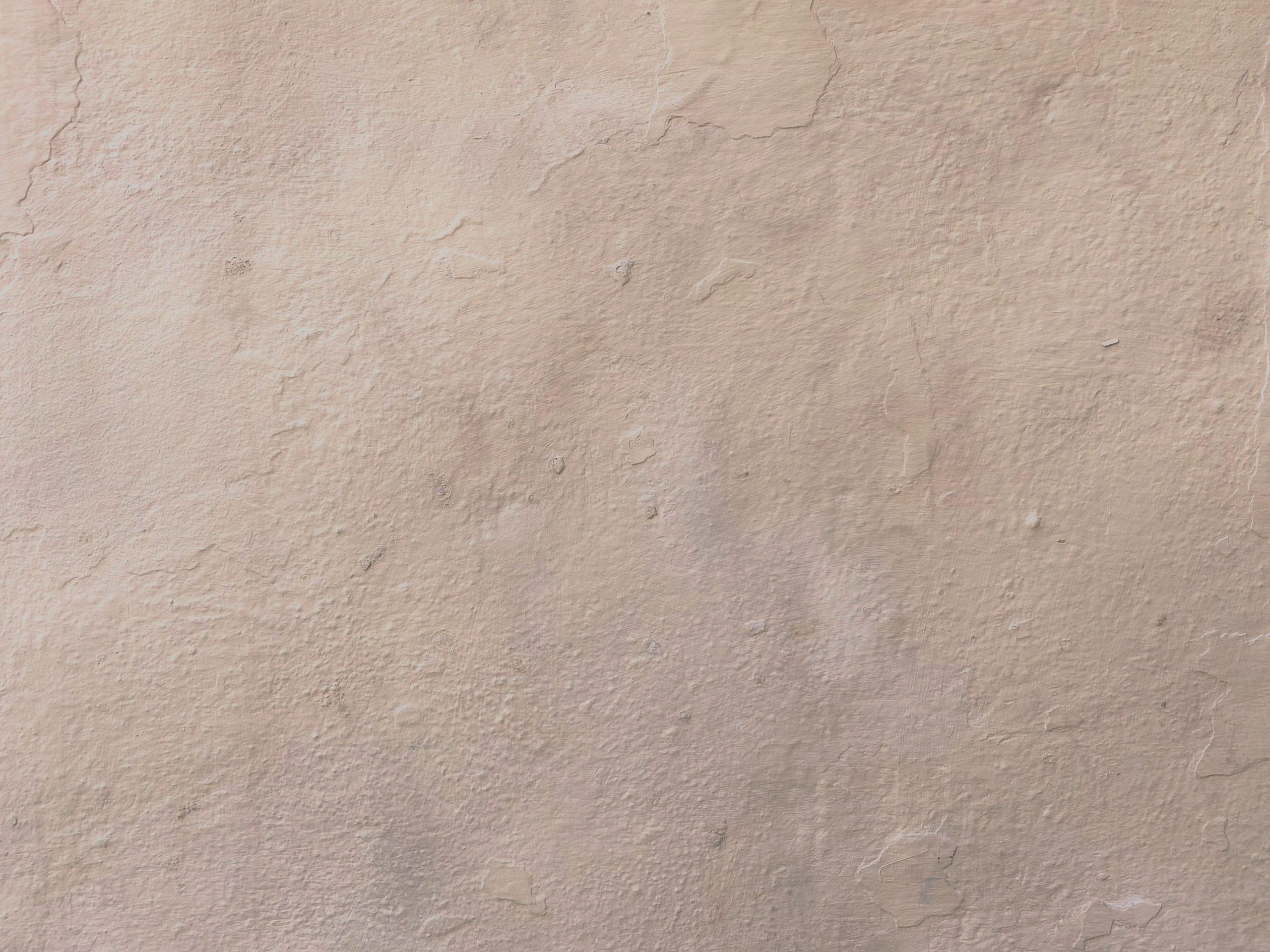 Surface murale plâtre beige texturée