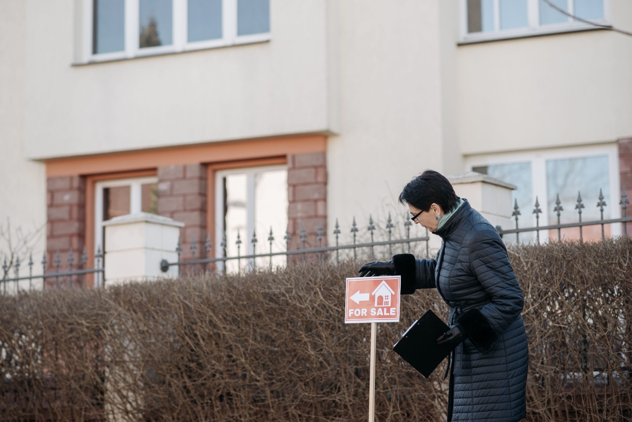 Agent immobilier affichant un panneau à vendre